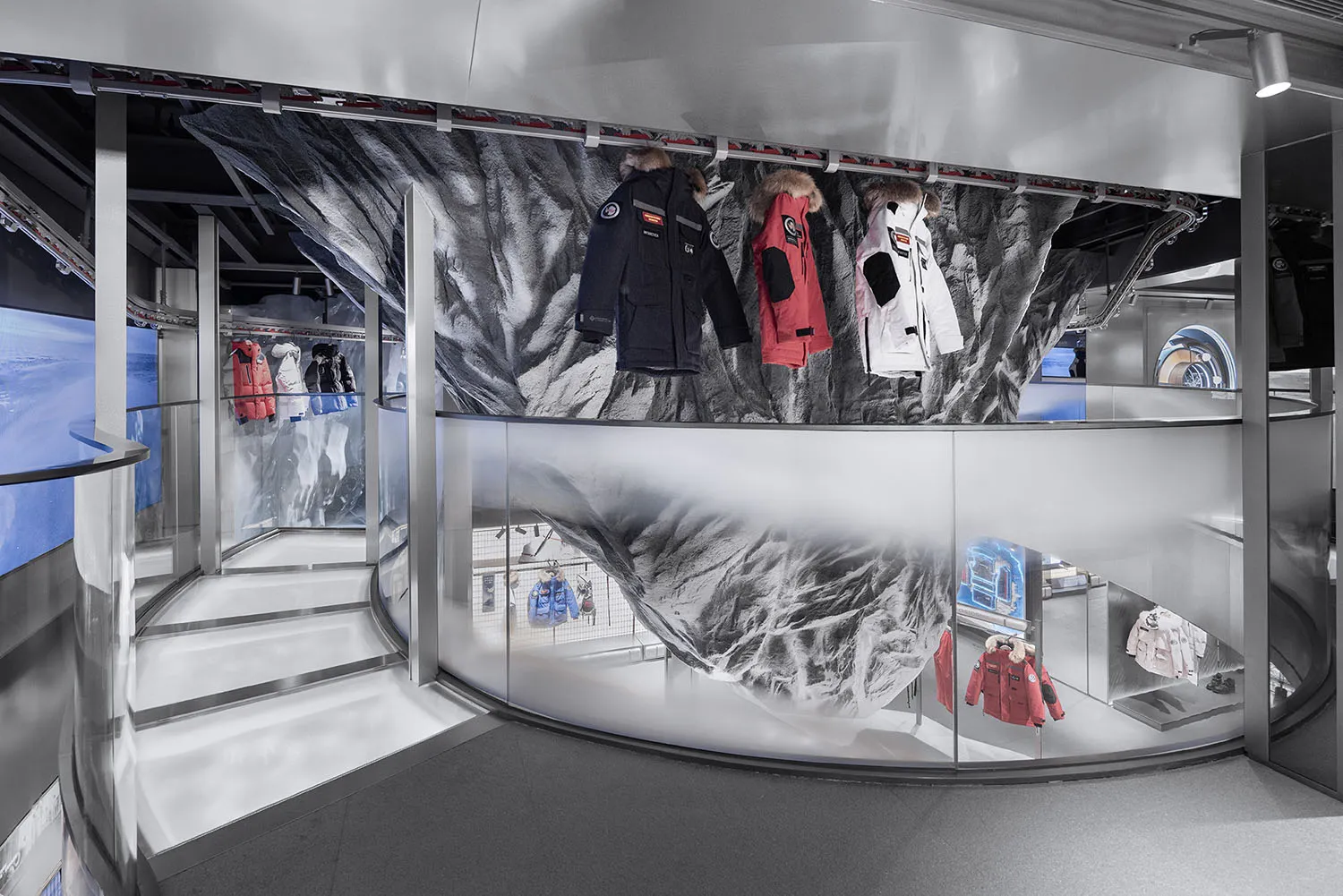 A retail interior showcasing a display of outerwear clothing.