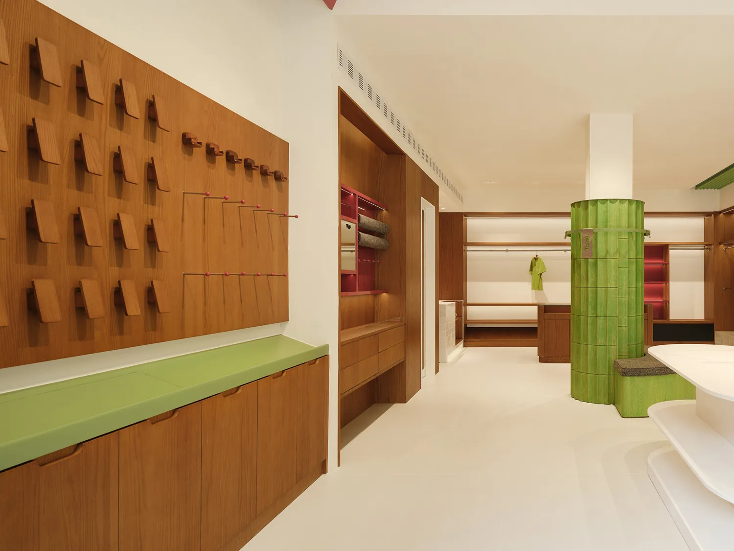 Modern retail interior featuring wooden shelving units and clothing racks