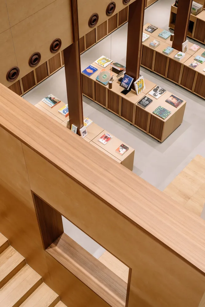 An overhead view of a modern bookstore interior with wooden shelves and displays.