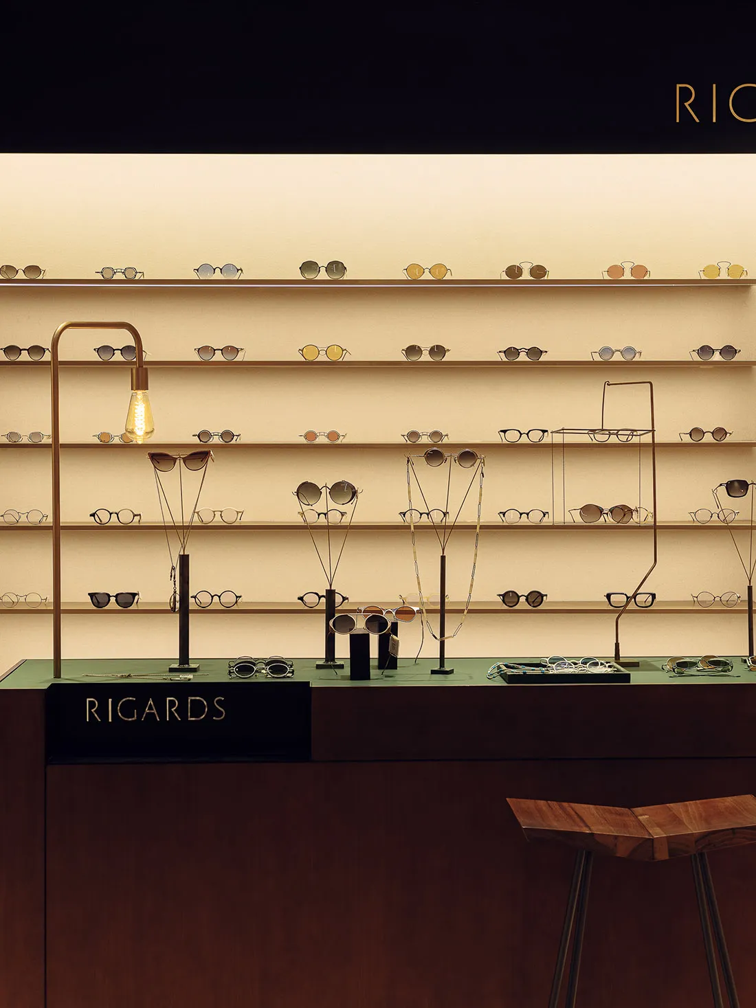 Display of sunglasses in a modern interior optical shop with wooden and steel elements