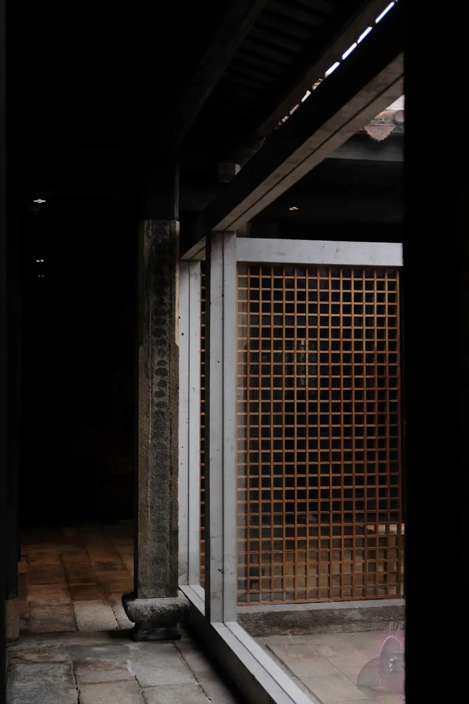 Concrete doorway with a wooden lattice window in an ancient structure
