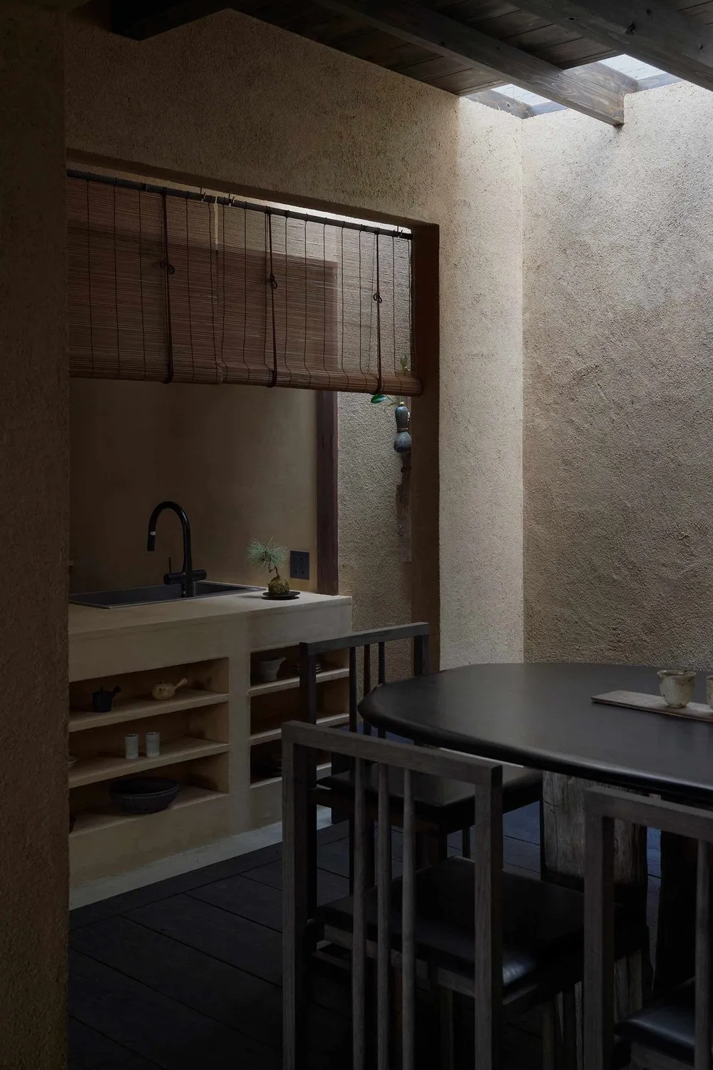 A minimalist interior space featuring Concrete and Timber materials.