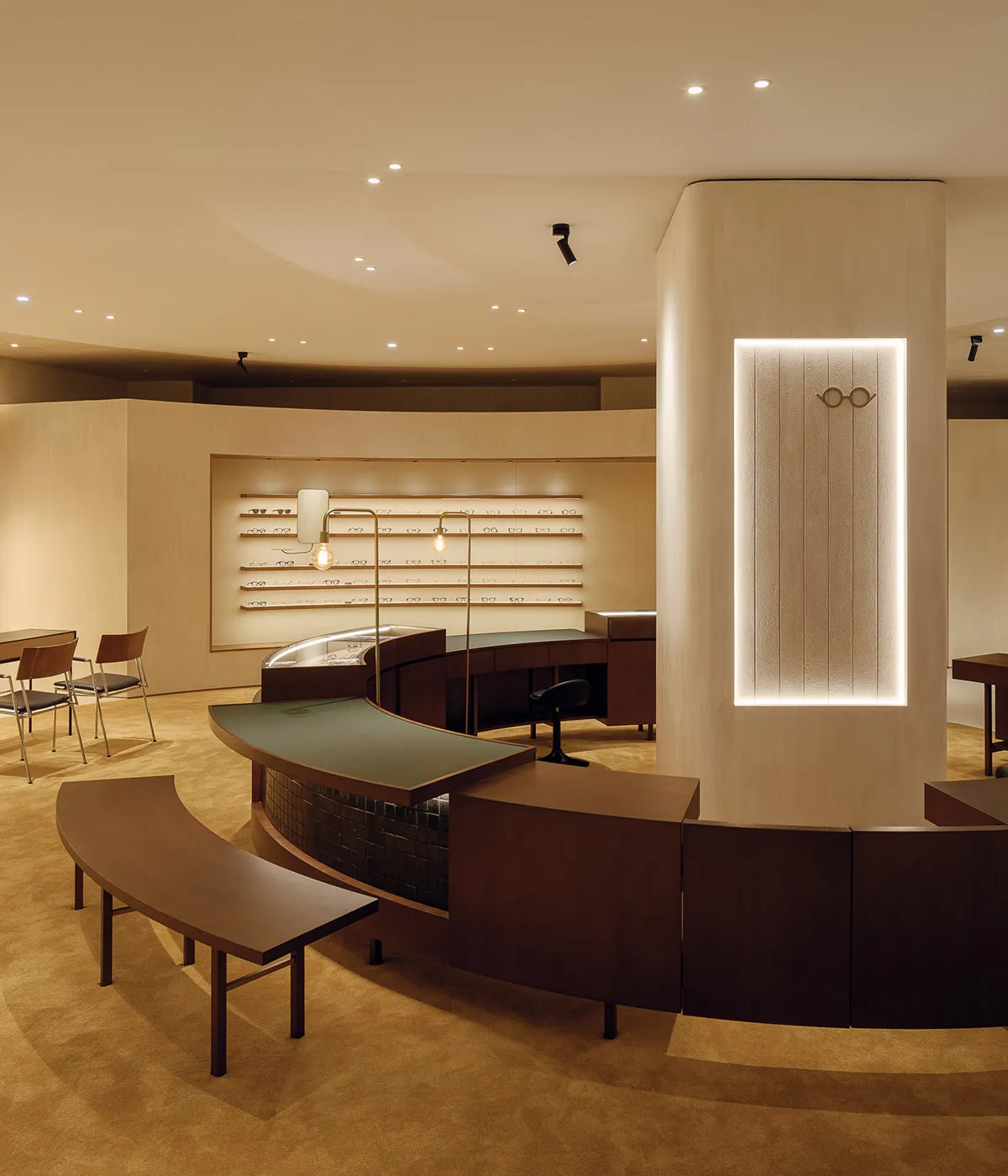 A minimalist retail store with concrete and wood finishes and a glass front window.