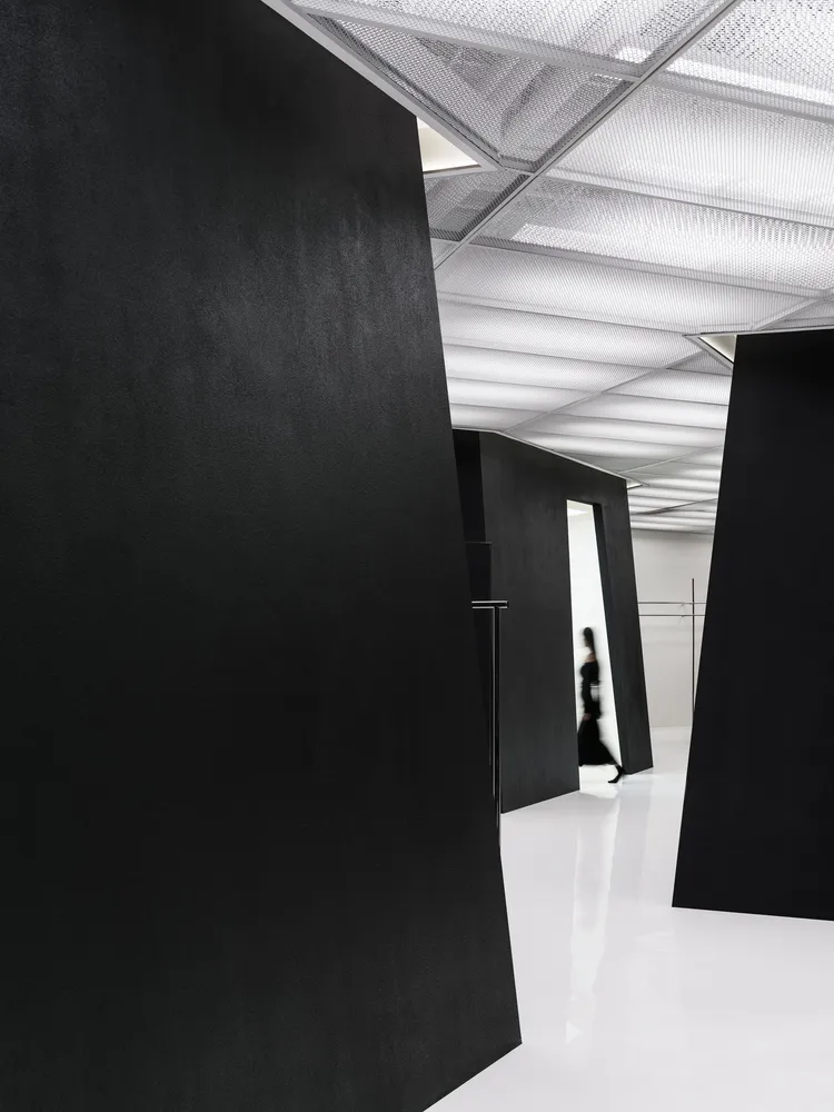 A minimalist black interior space with clean lines and a sleek design.