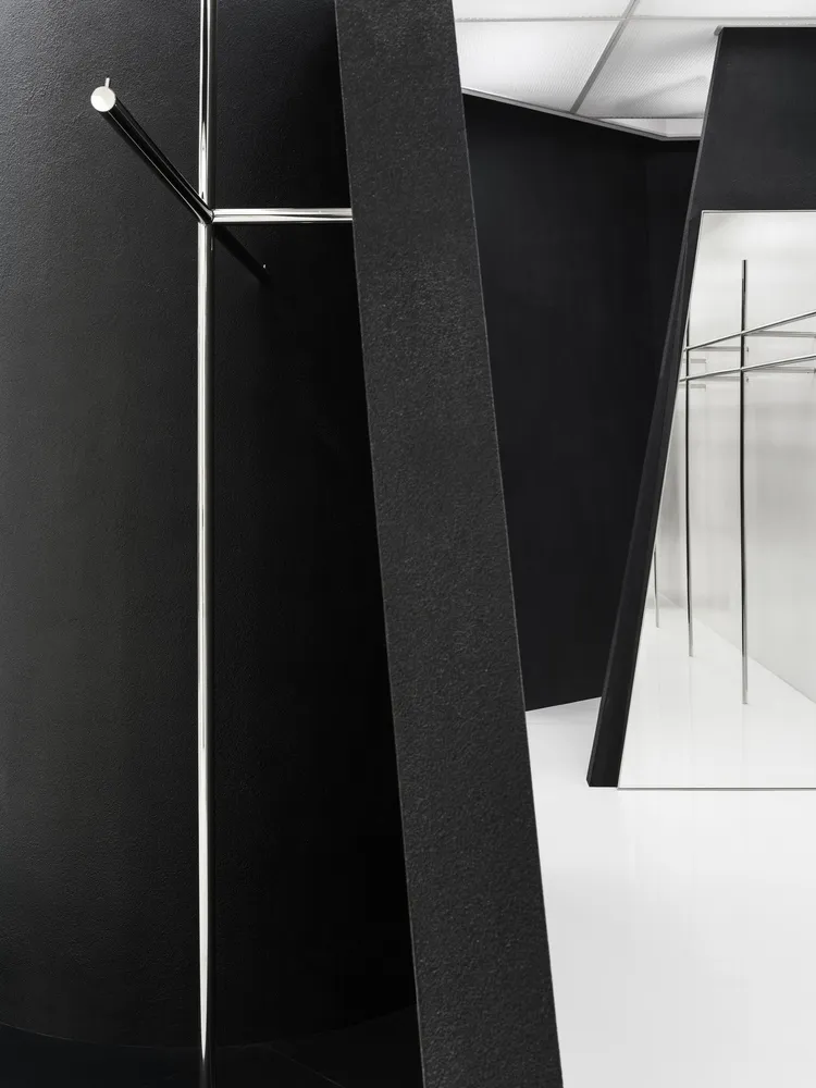 Black metal coat rack in a minimalist interior