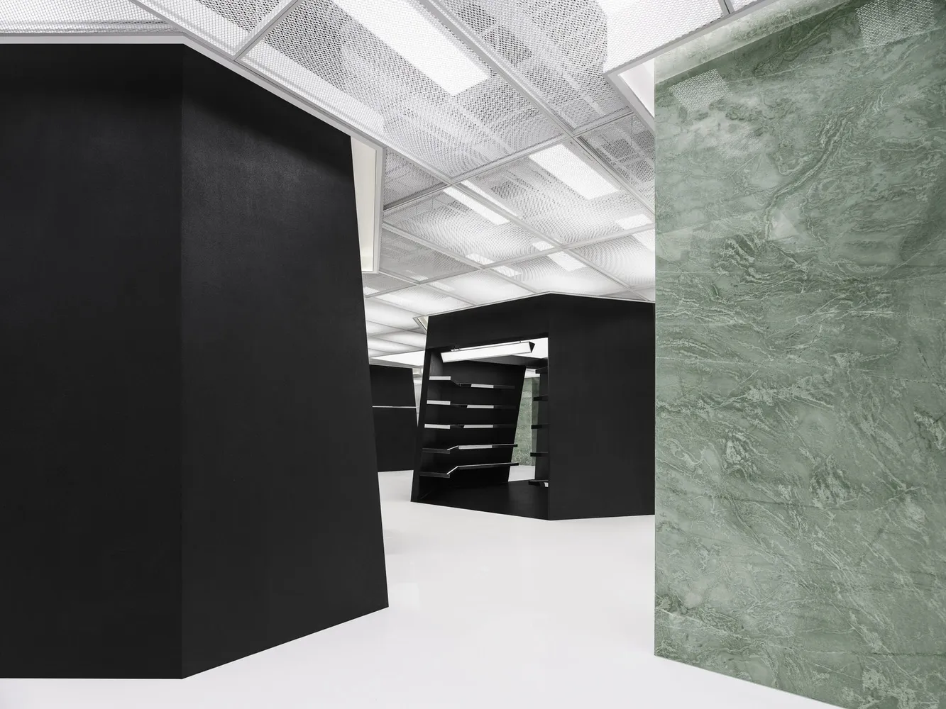 An office space featuring modern design with concrete and glass materials.