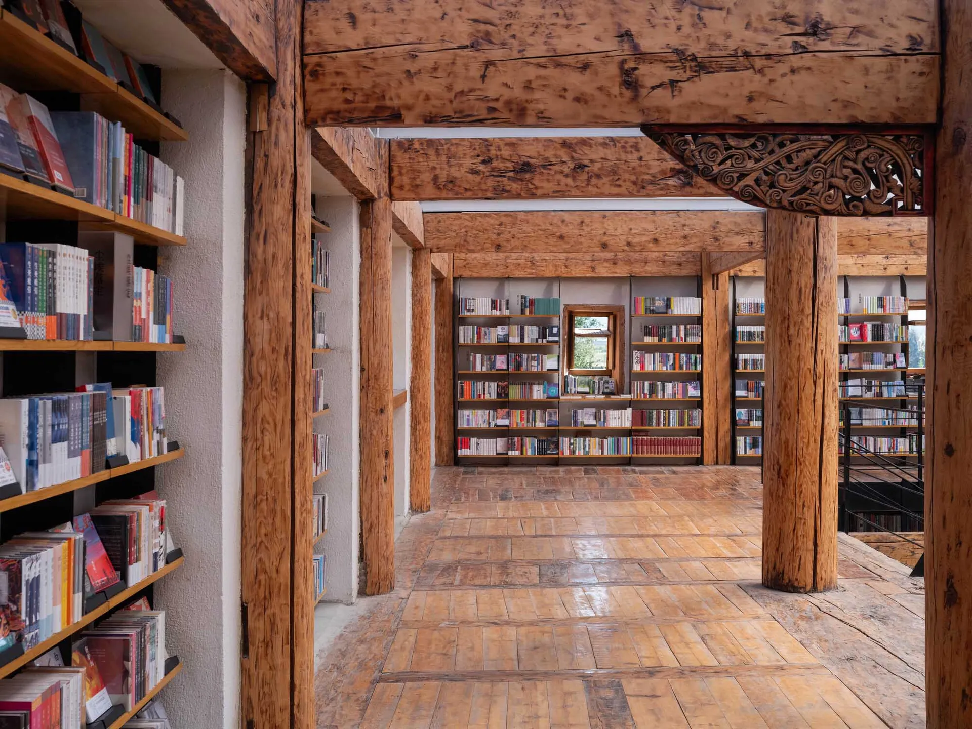 A wooden library with bookshelves filled with books.