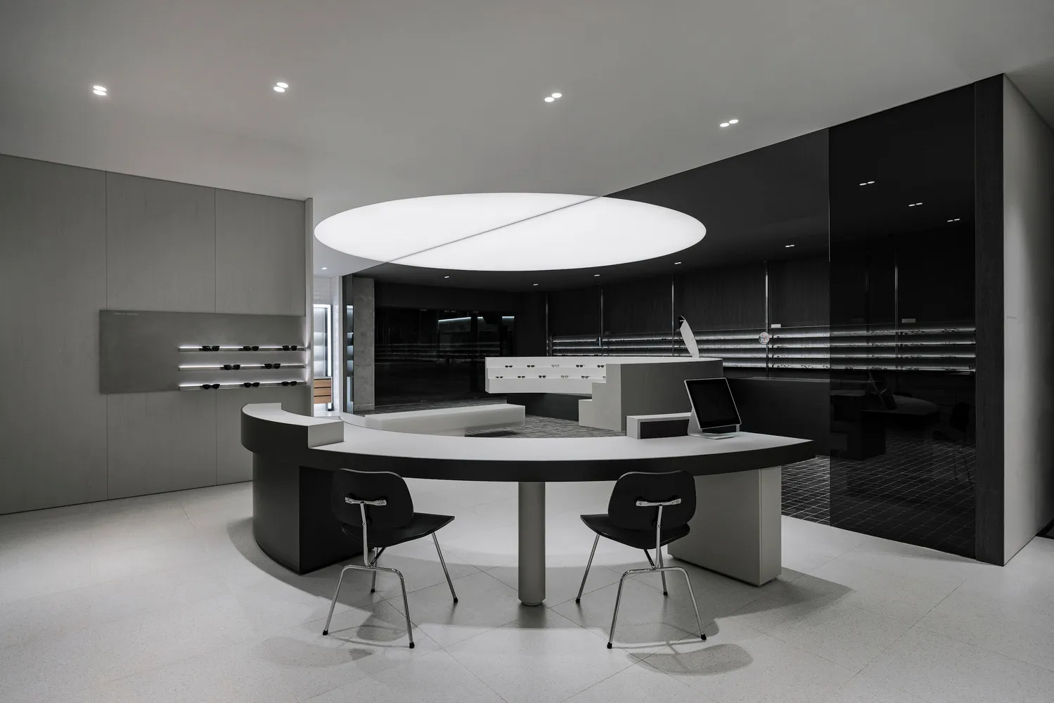 Minimalist retail store featuring concrete and glass materials.