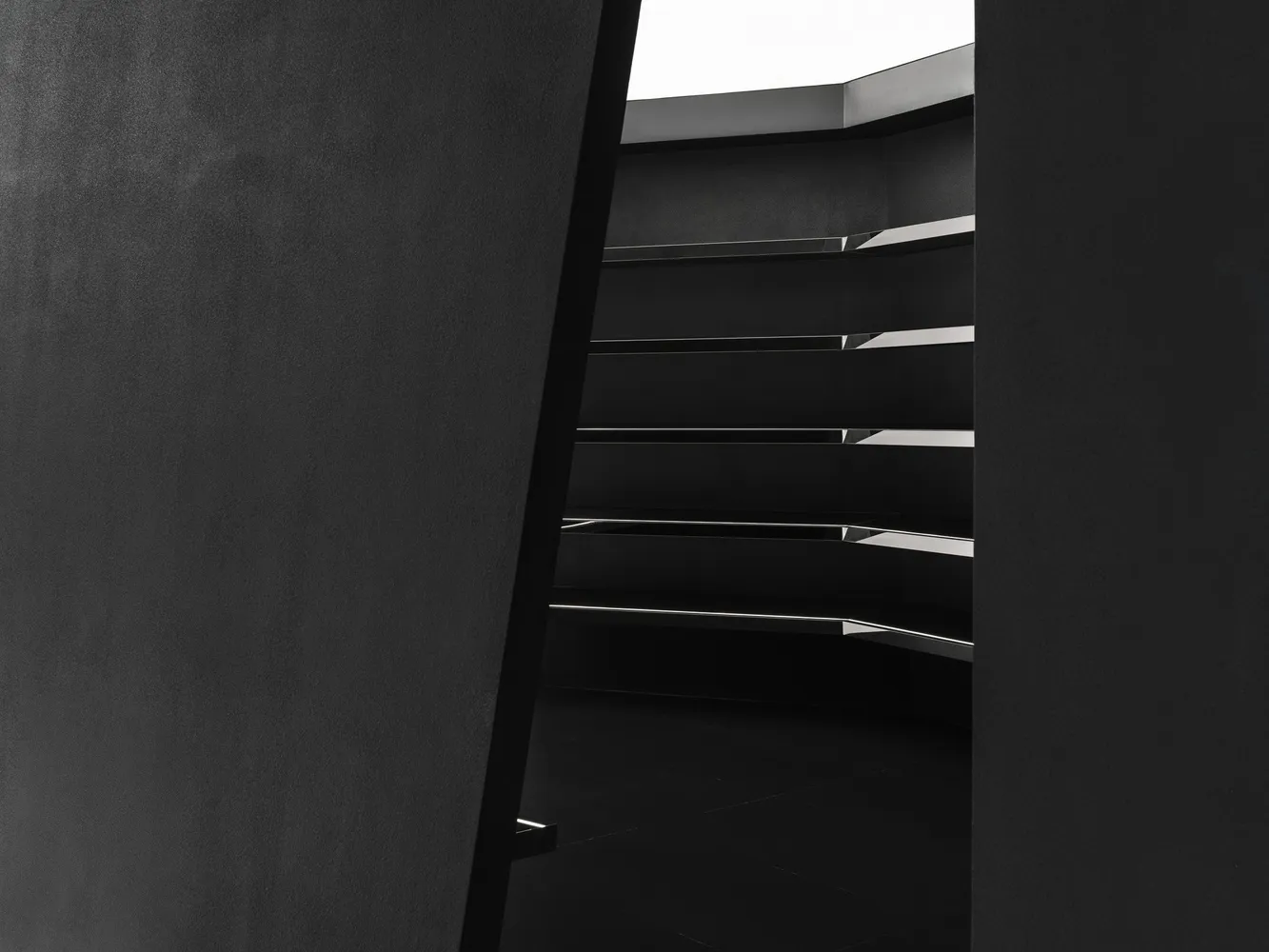 Modern black staircase with metallic elements.