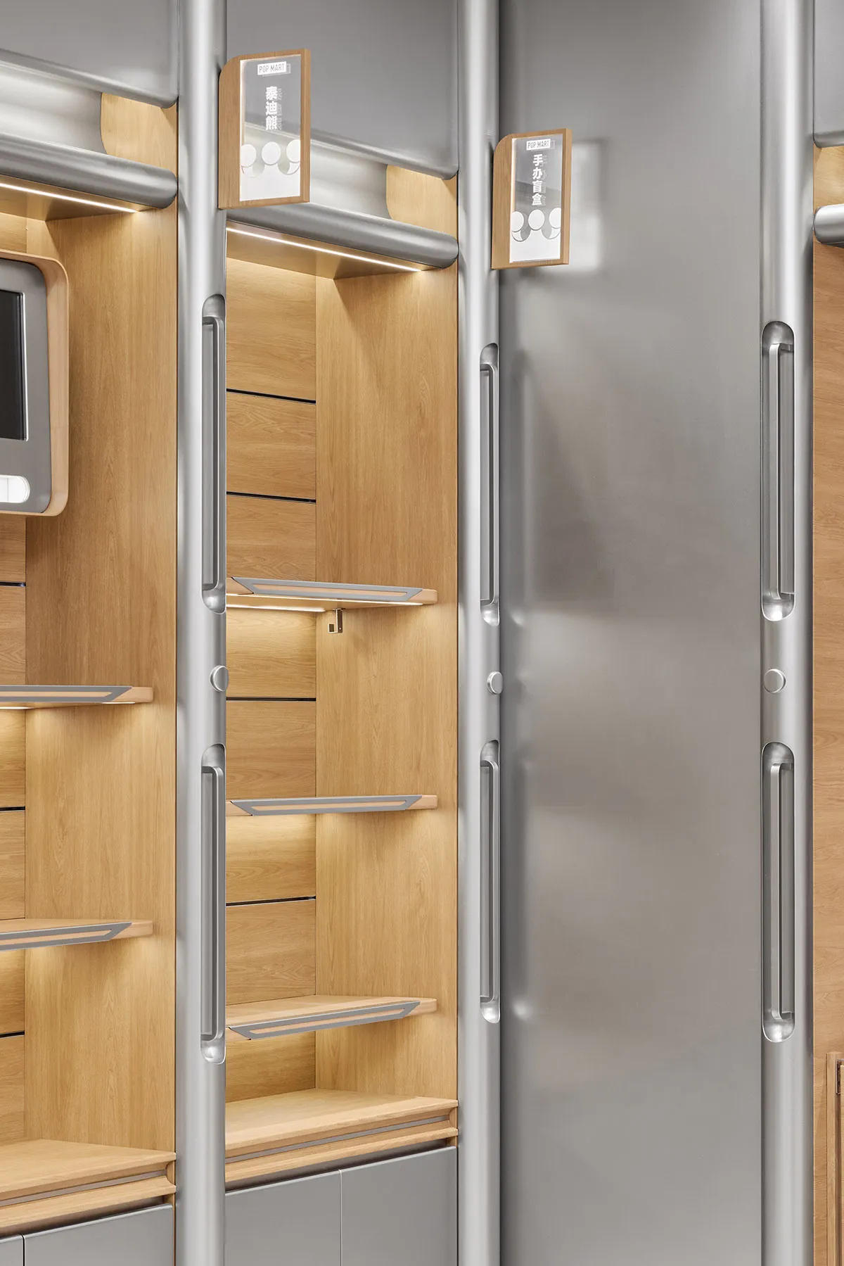 A modern retail display with wooden shelves and metallic rails and handles.