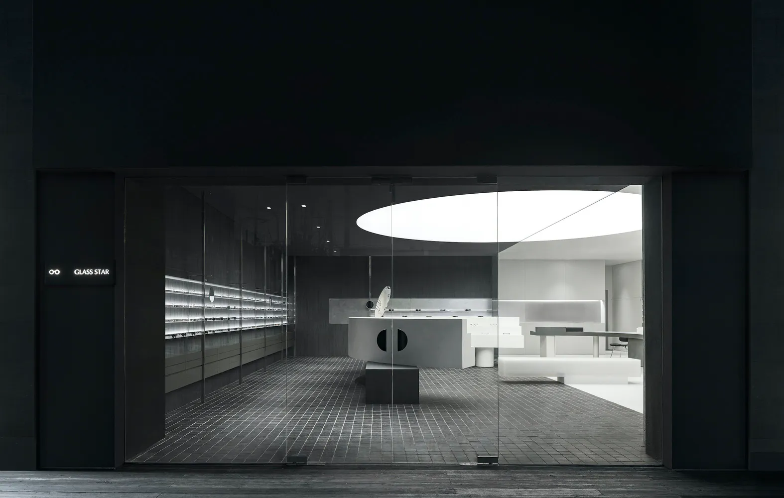 A modern retail space featuring glass, metal, and concrete materials.