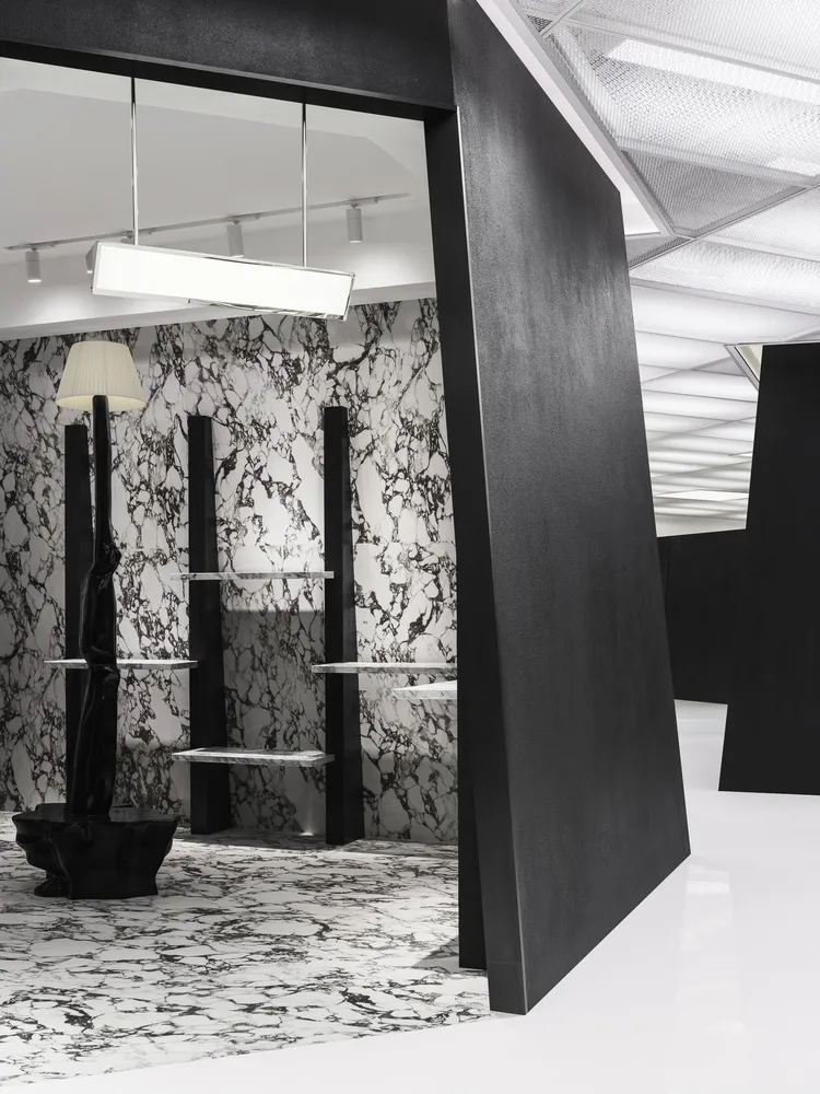 A modern retail storefront featuring a combination of concrete and marble materials.