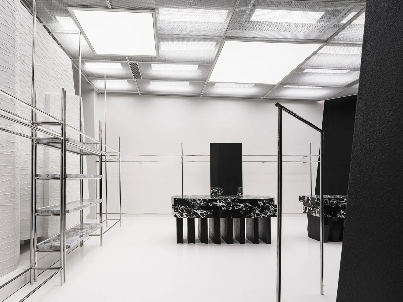 A modern commercial space featuring marble and concrete shelves.
