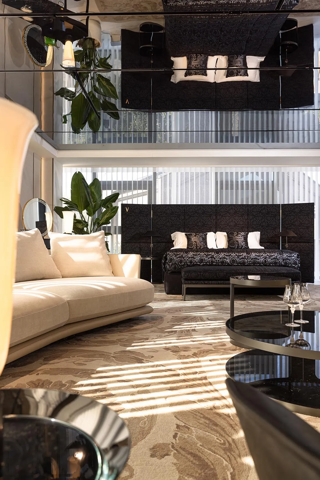 A modern living room featuring a comfortable, circular sofa with plush cushions.
