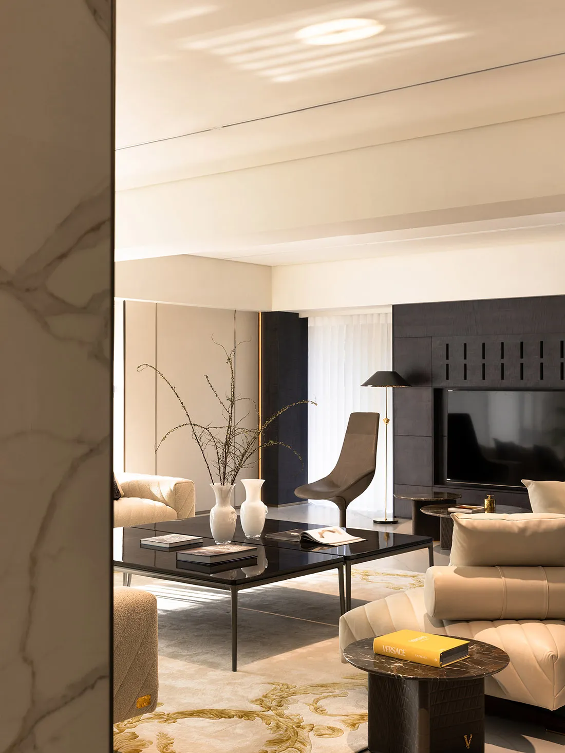 Modern living room featuring marble accents and leather furnishings