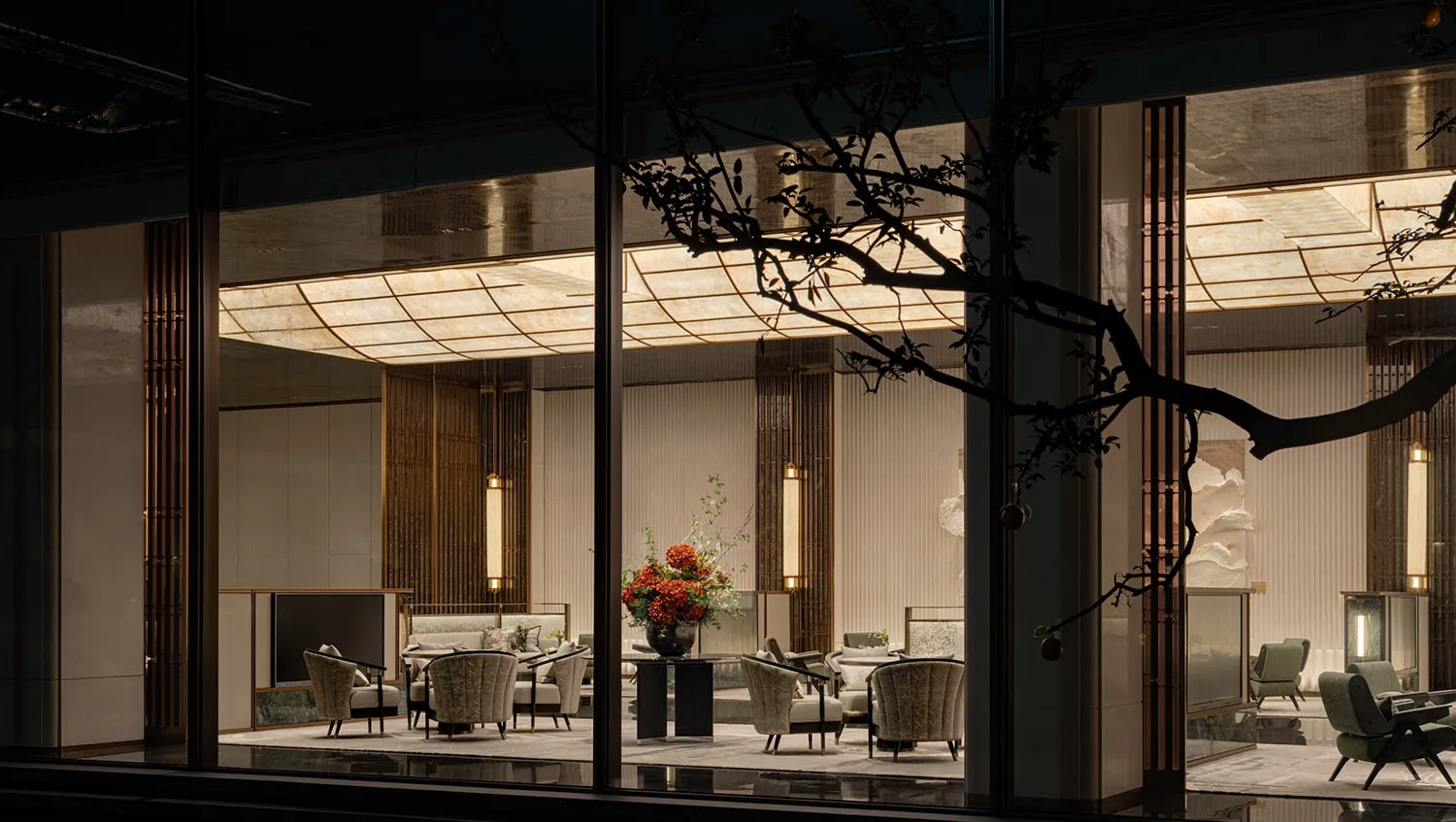 Minimalist hotel lobby featuring stone, glass, and metal materials.