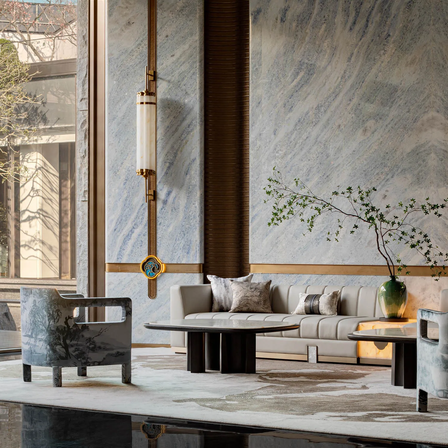 Modern living room with marble walls and leather furniture.