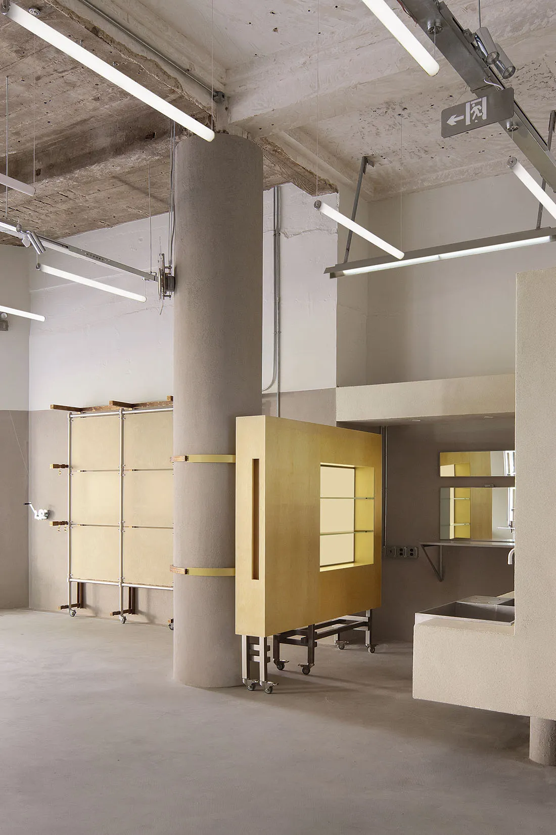 A modern office space with concrete columns and exposed roof beams.