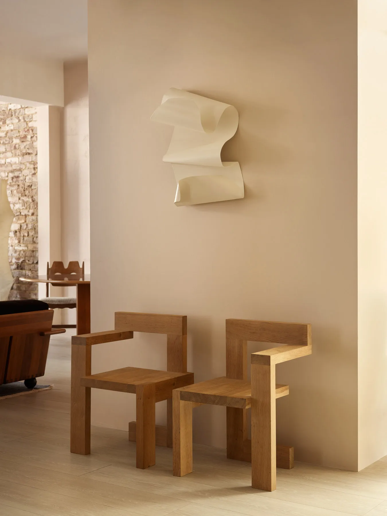 A modern interior design featuring wooden furniture with unique geometric shapes.