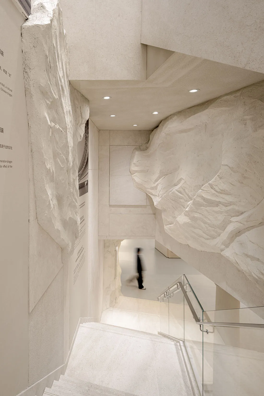 A modern building interior featuring stone and concrete materials with a minimalist design.
