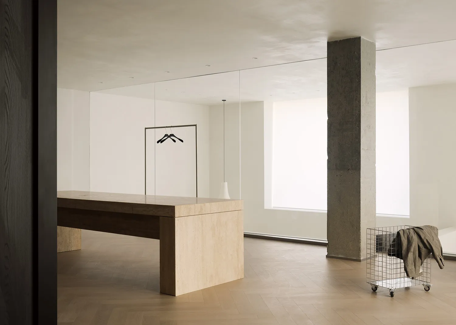 Modern minimalist living space featuring concrete, wooden, and metallic elements.