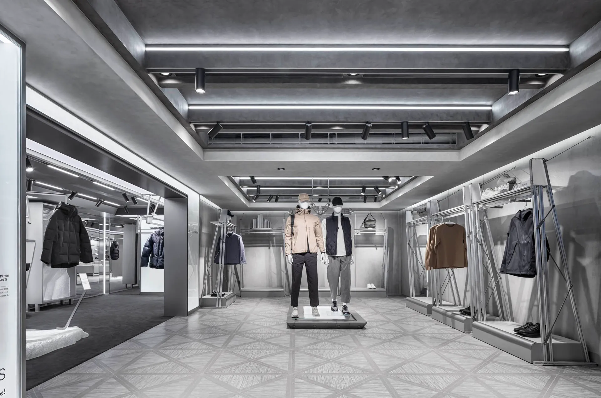 A modern retail display showcasing clothing items in a metallic setting.