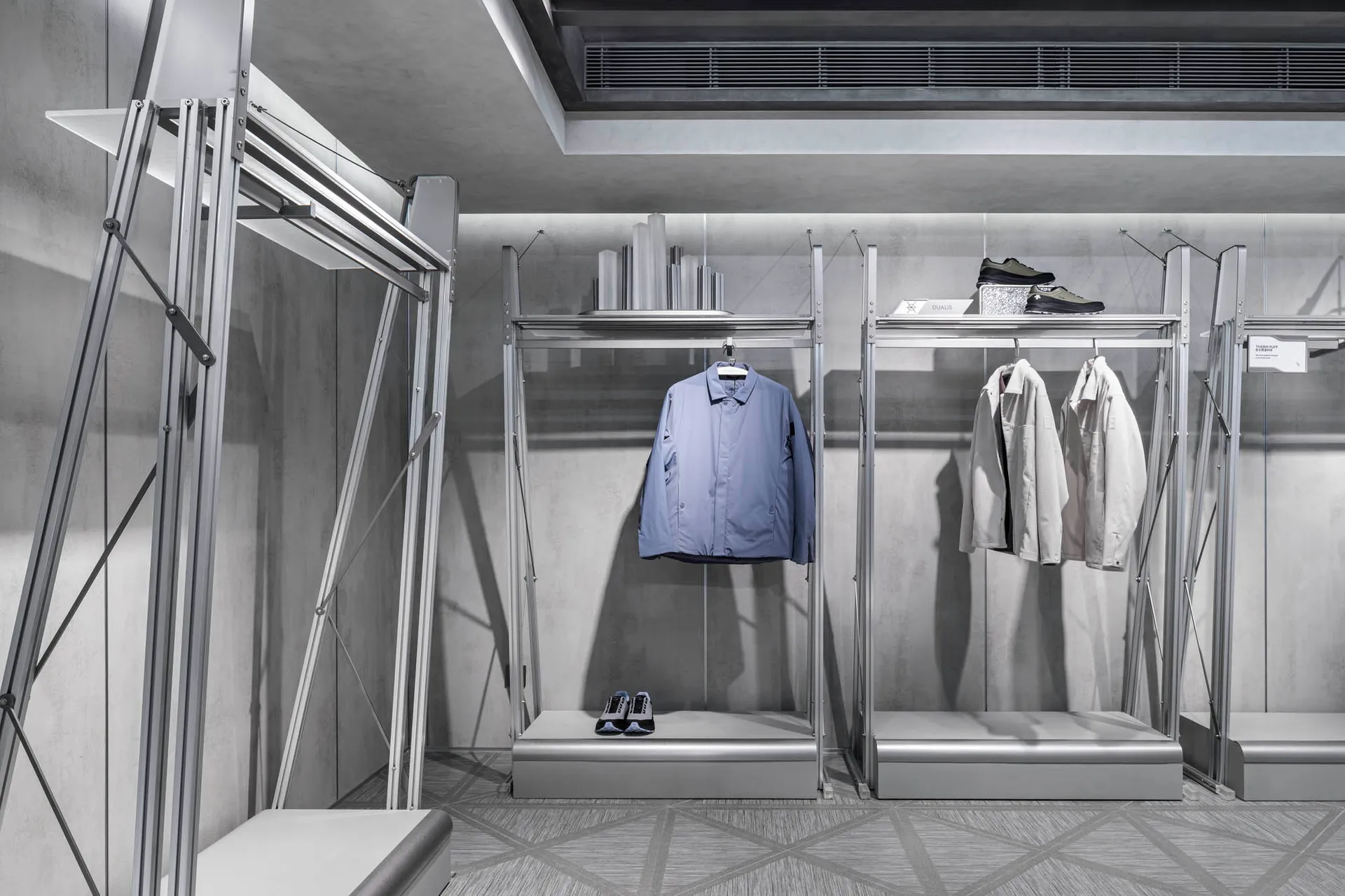 Modern retail storefront featuring metal icons and clothing display