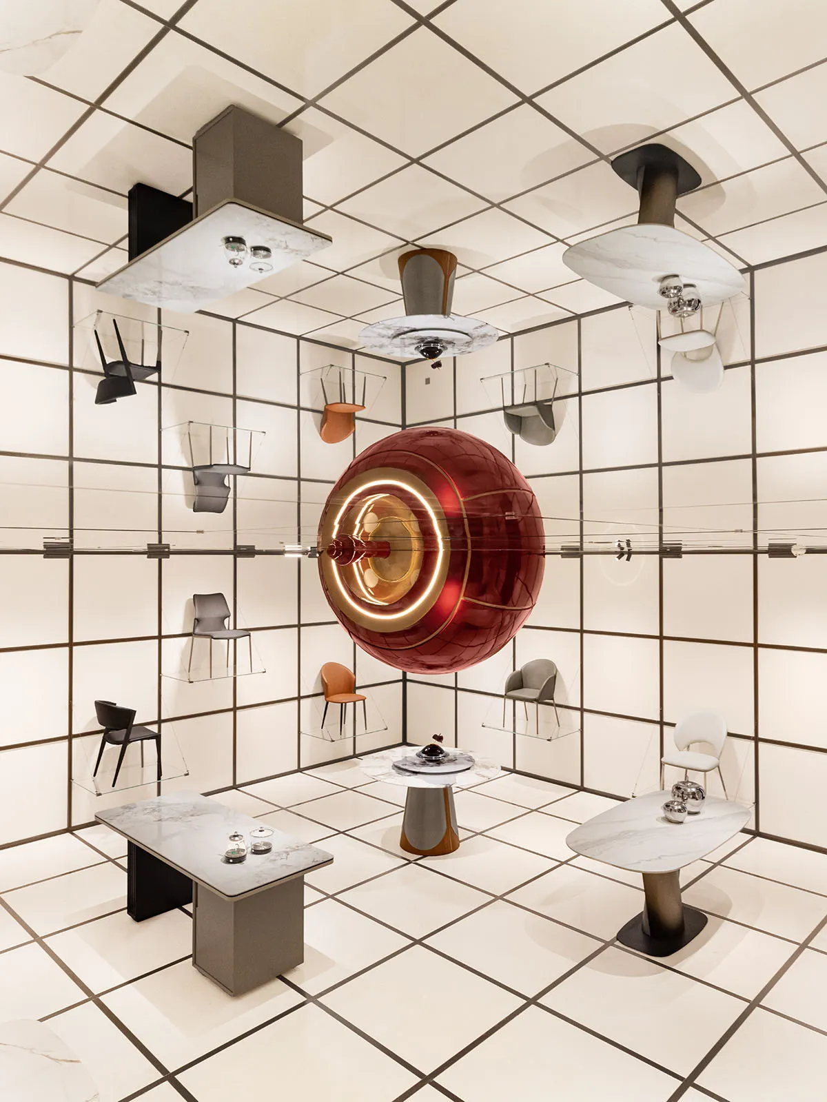 A modern retail storefront featuring a large metallic red sphere.