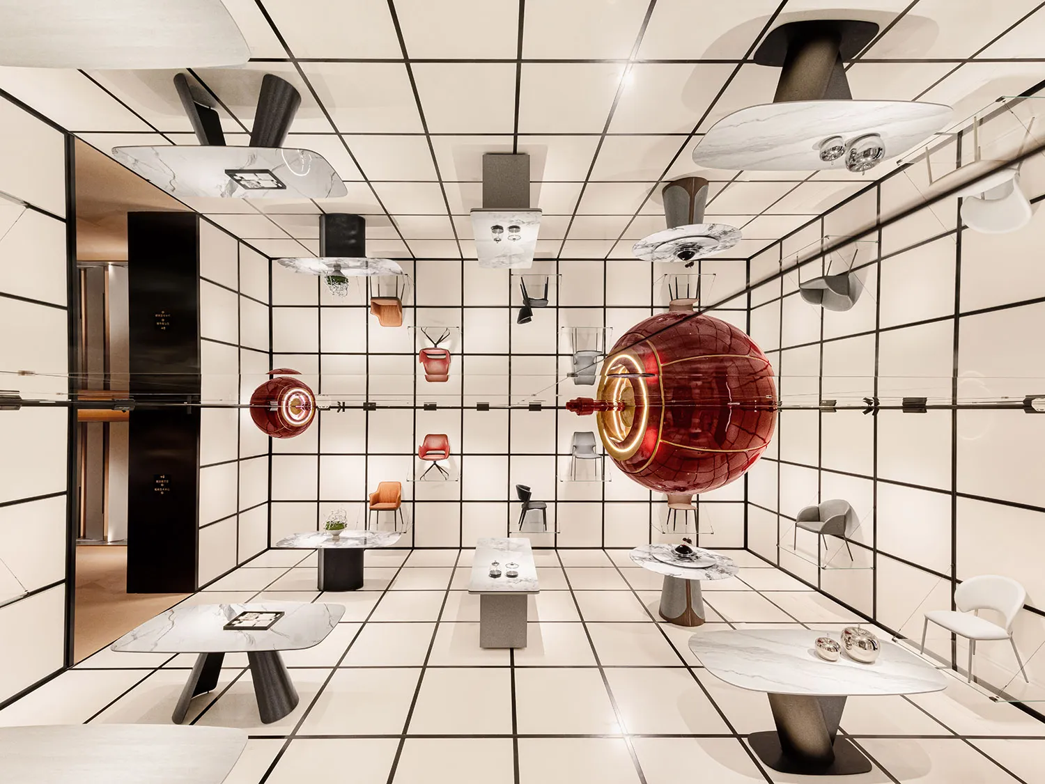A modern retail space featuring marble and glass materials, with furniture and tables showcasing contemporary design.
