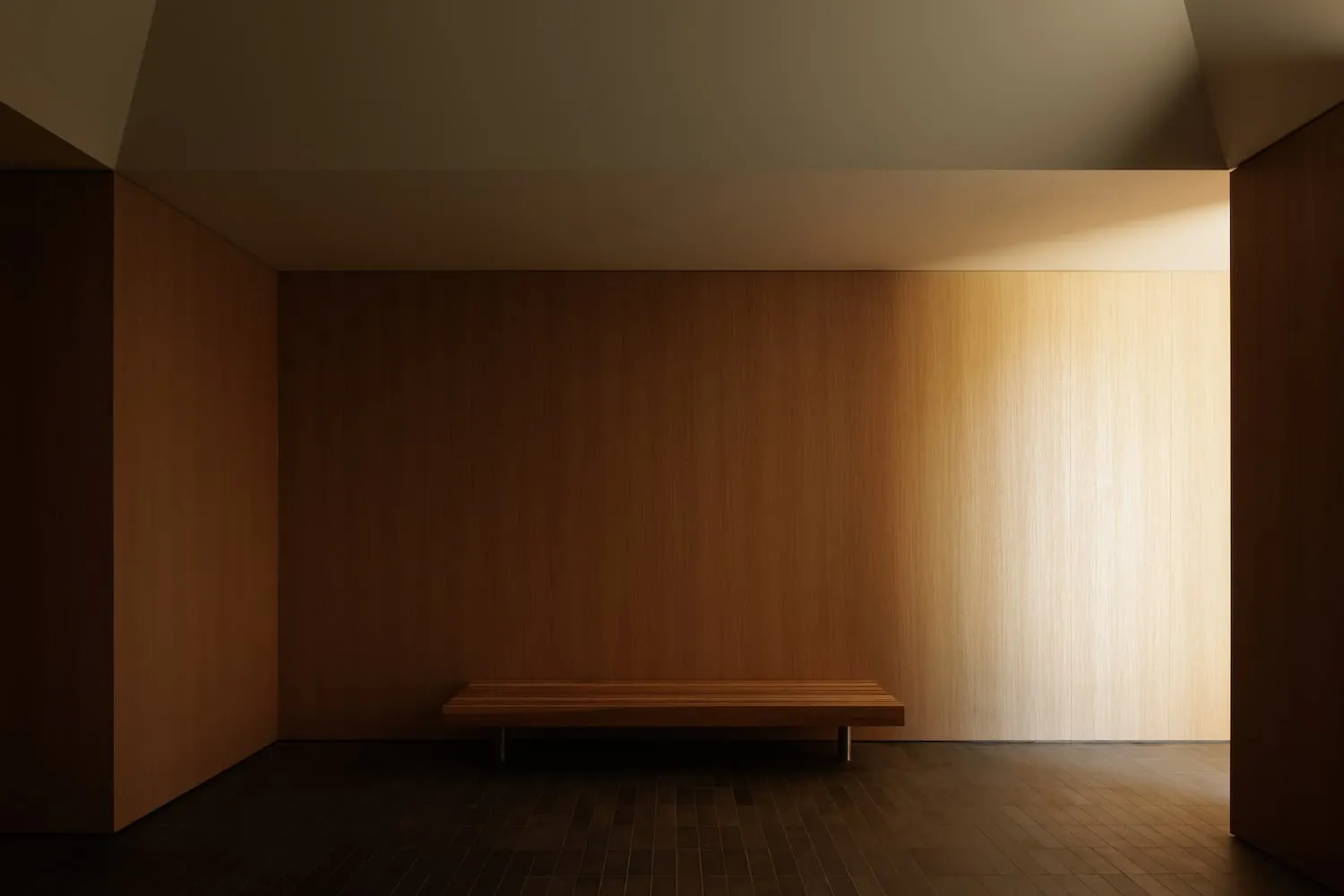 Minimalist room with wooden furniture and sunlight shining through a window.