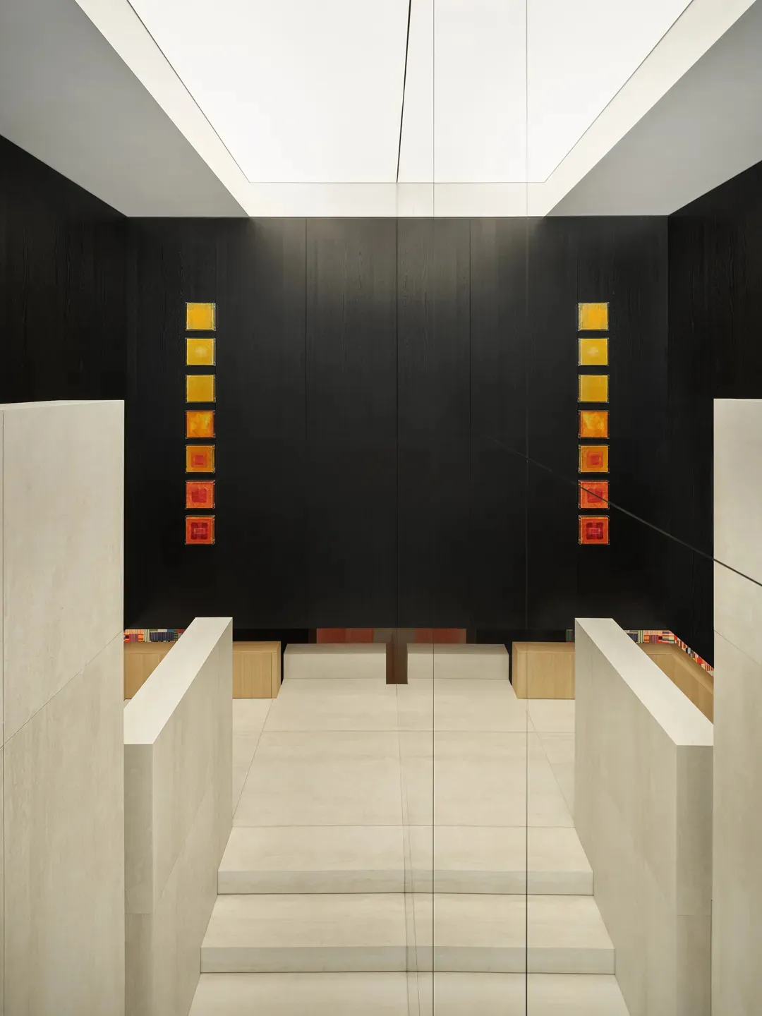 Modern retail storefront featuring a minimalist design with concrete and glass materials.
