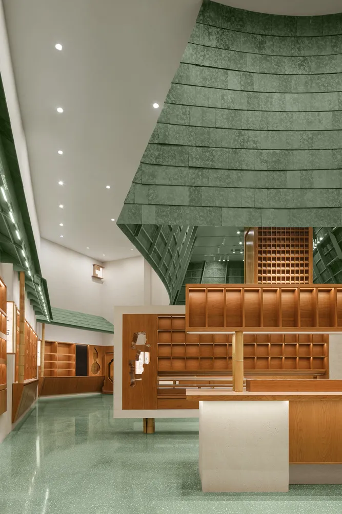 A modern bookstore with wooden features and a green, textured floor.