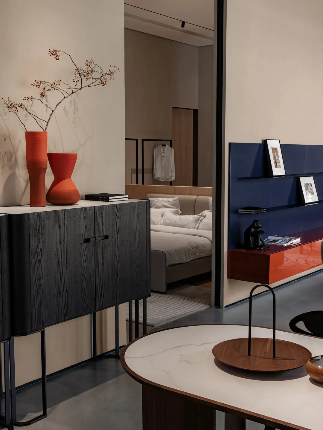 Modern interior design featuring metal, wood, glass, and fabric elements in a living space.