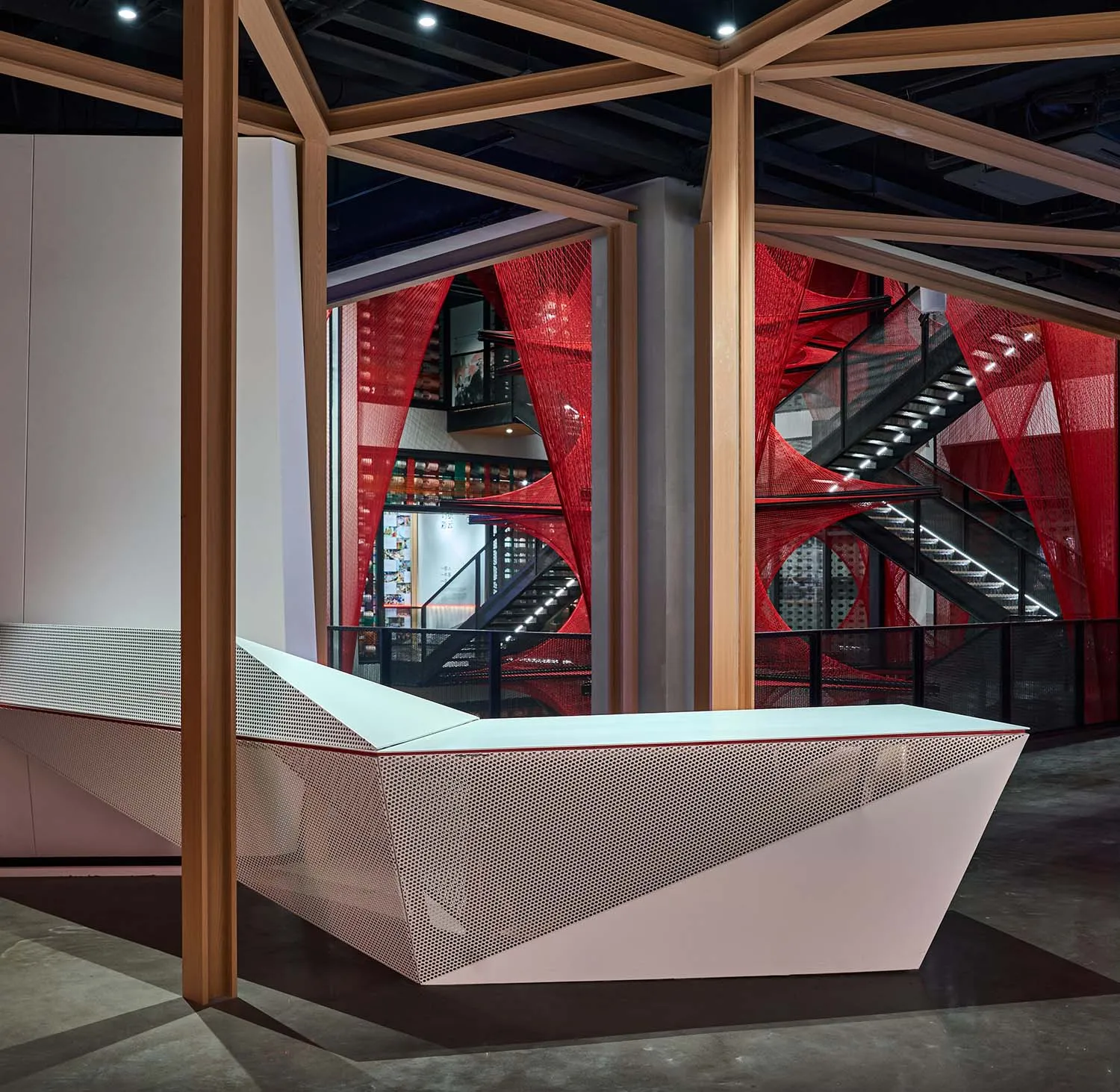A modern reception desk made of perforated metal material.