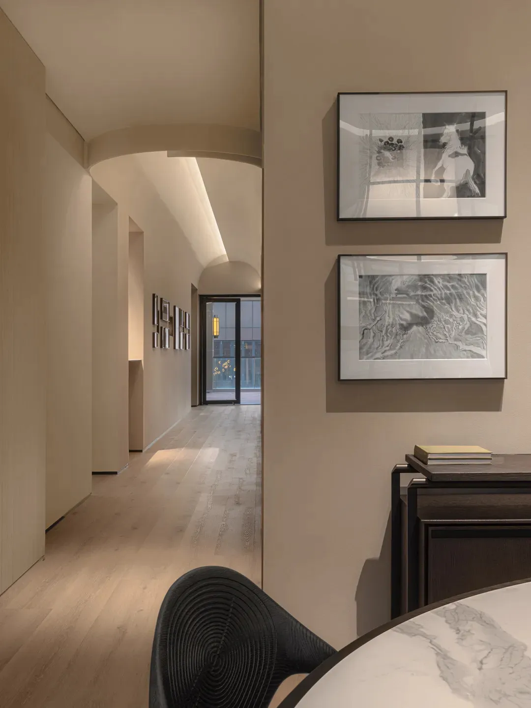 A modern interior space with wooden flooring and light fixtures.
