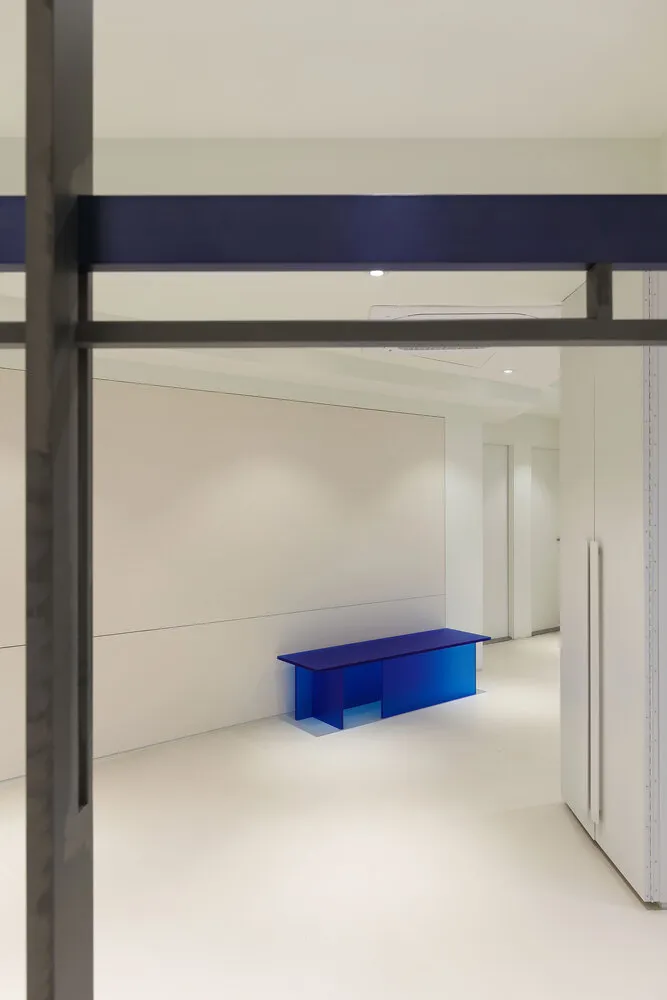 Modern office interior with a sleek, minimalist desk and white background.