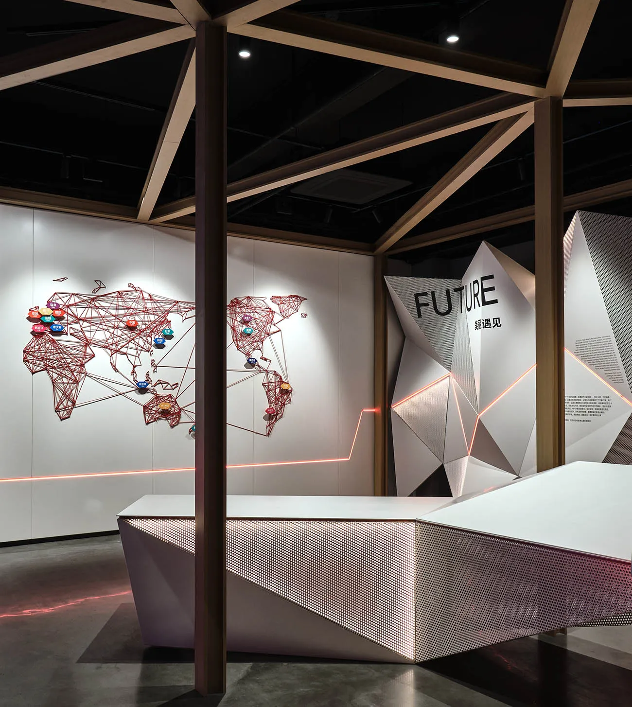 A modern exhibition space featuring geometric shapes and metallic elements.