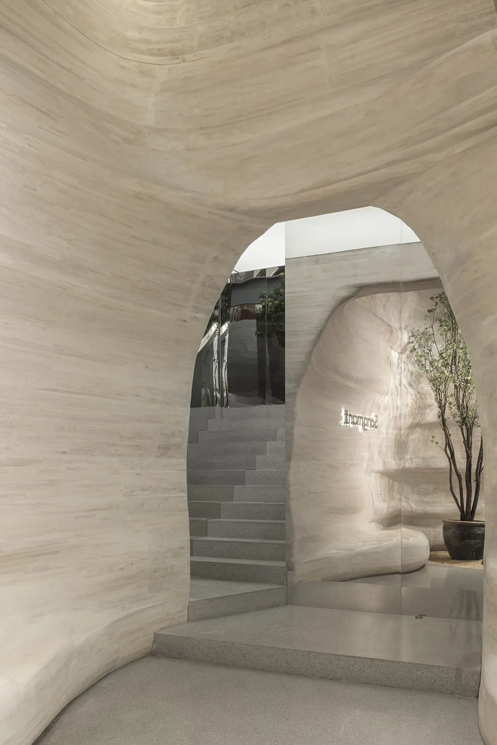 A modern reception area with concrete walls and floors.