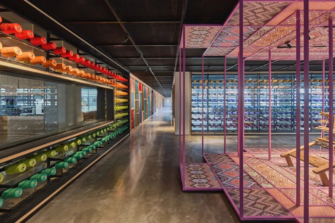 Modern retail store with glass displays and colorful carpeting.