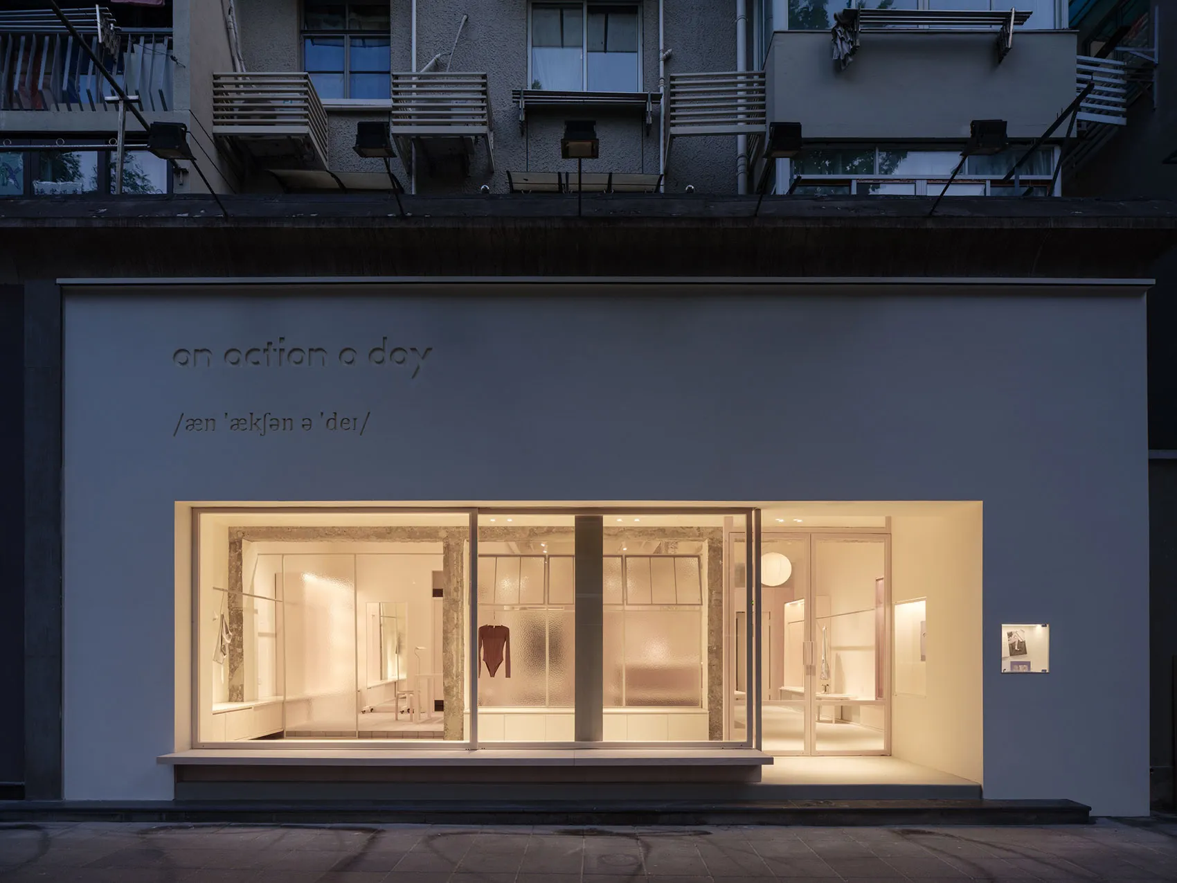 A modern retail storefront featuring glass and concrete materials.