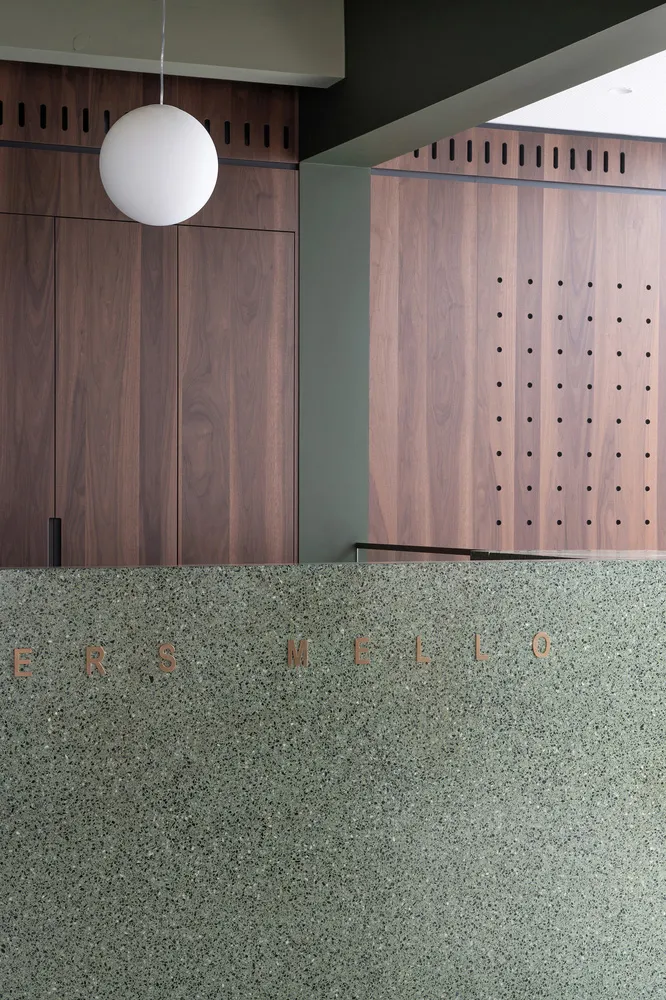 Modern coffee shop interior featuring wood, concrete, and terrazzo materials.