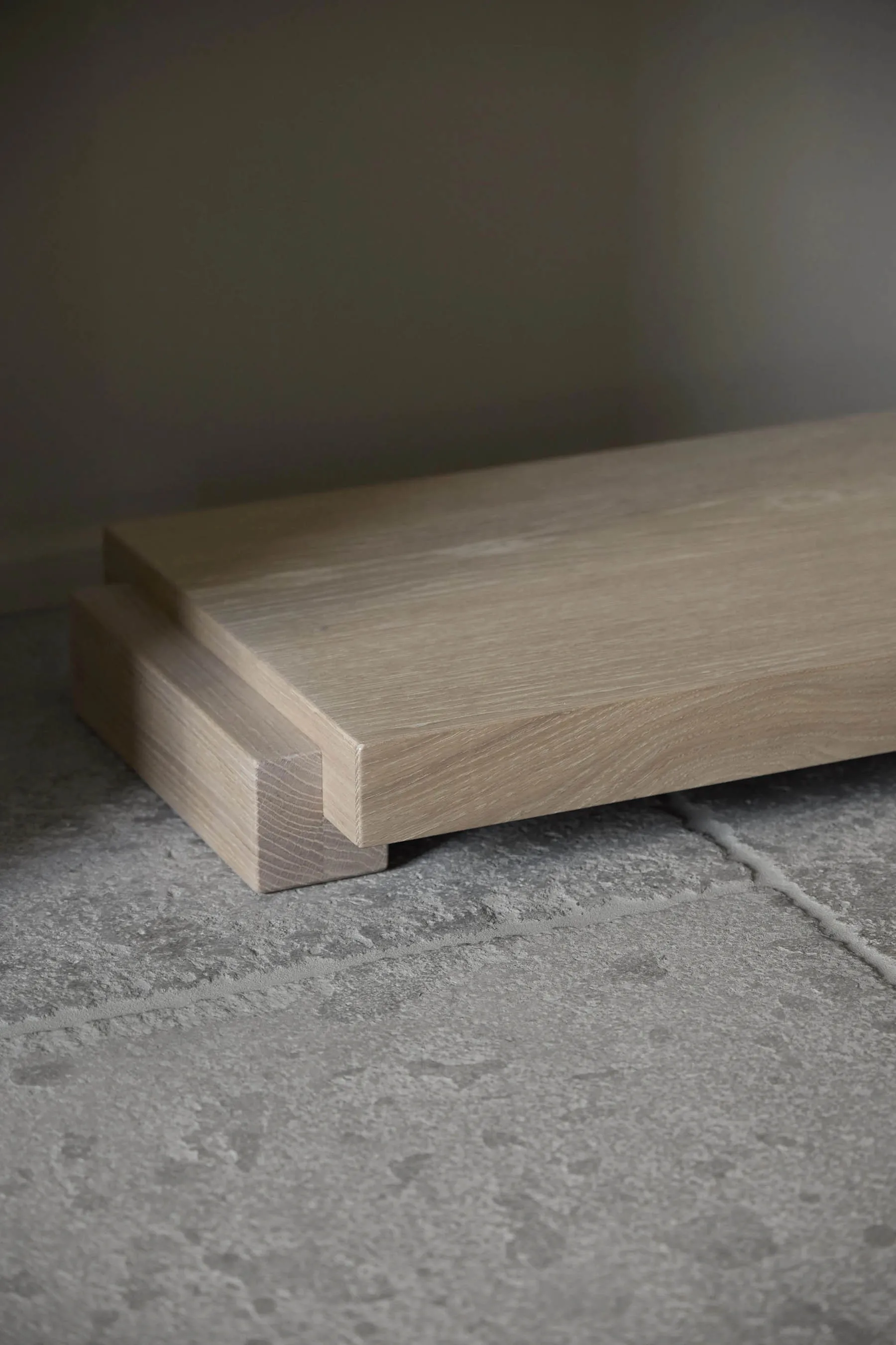 A minimalist, light-colored oak floating console table with clean lines and a smooth surface.