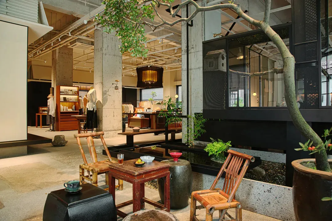 A modern industrial retail shop featuring a mix of concrete and wooden elements.