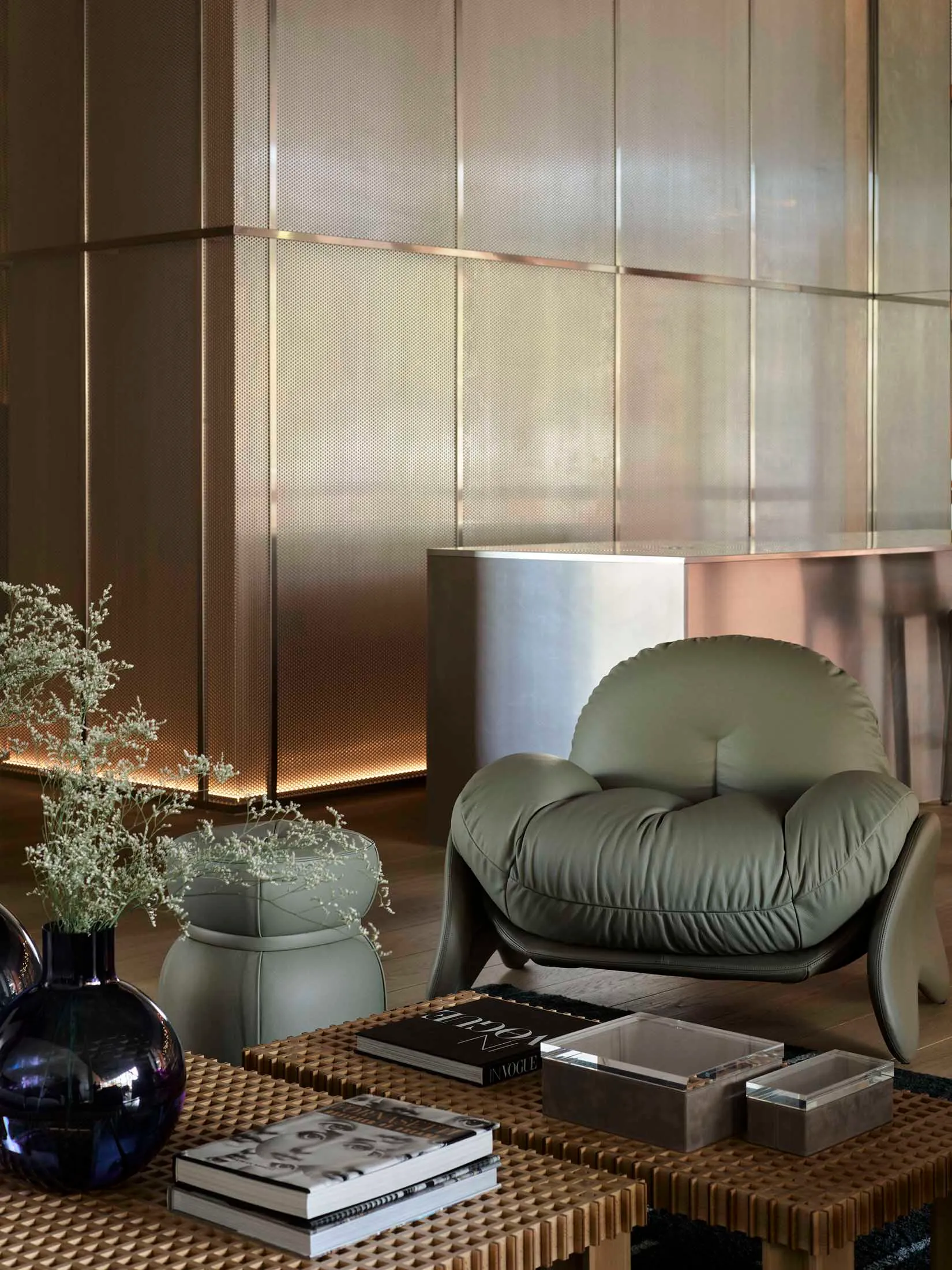 A modern living room featuring a plush leather armchair with comfortable cushions.