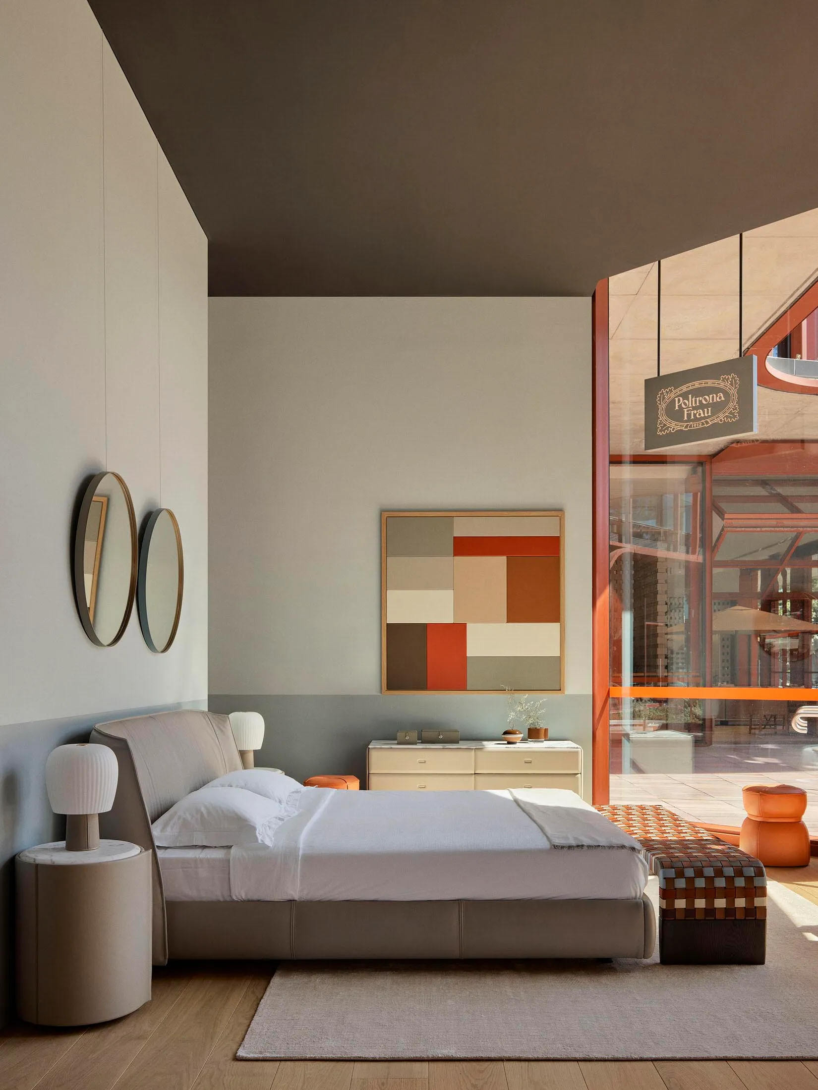 A minimalist bedroom with a modern design featuring a low-profile bed, sleek nightstand, and abstract wall art.