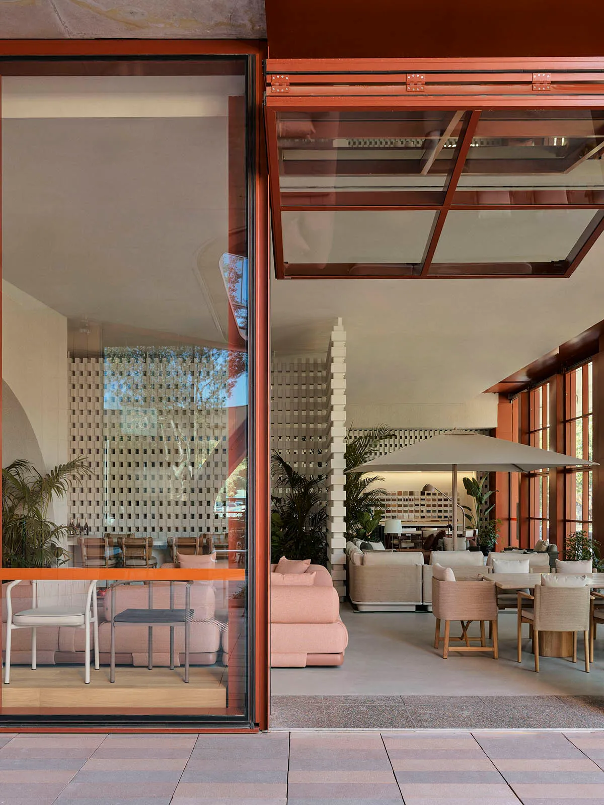A modern office interior with large glass windows and minimalistic furniture.