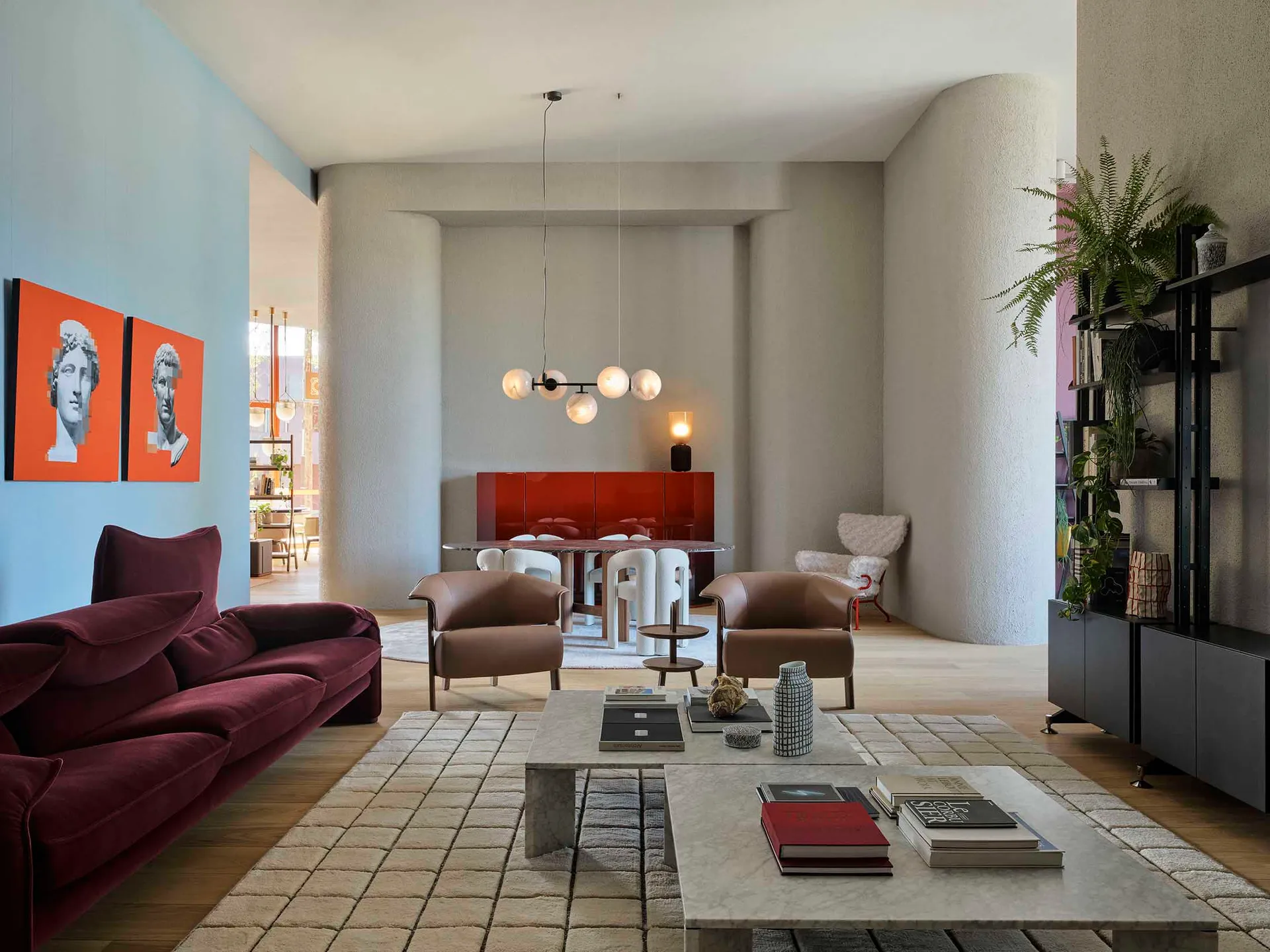A modern interior living room with a marbled coffee table, leather armchairs, and a concrete column.