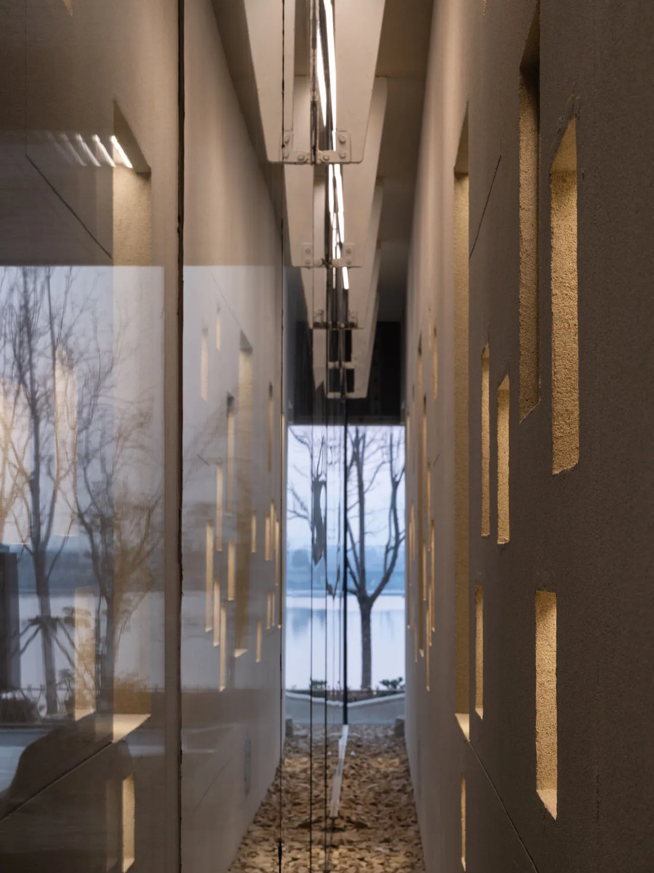 Modern entryway with glass doors and concrete walls