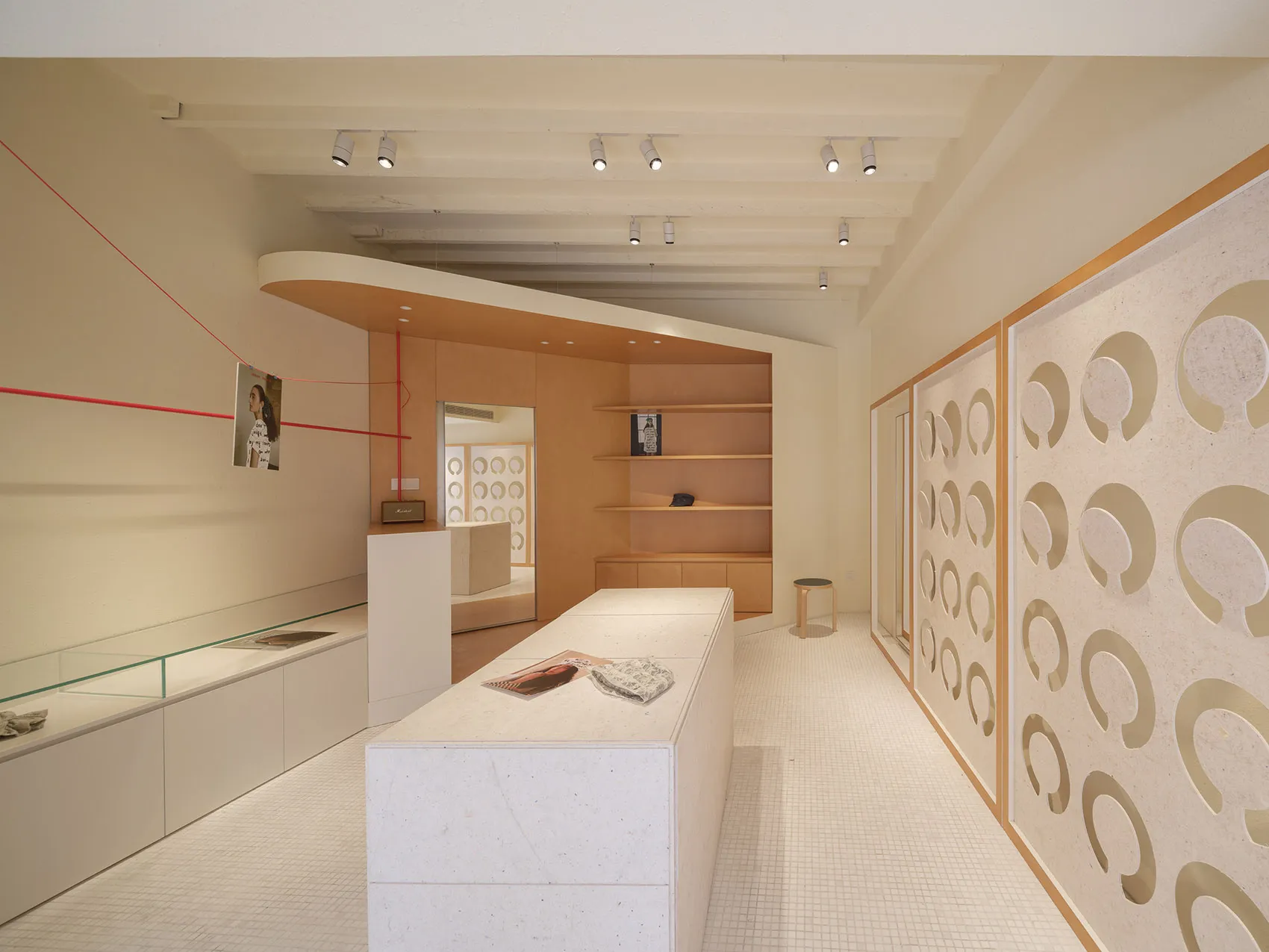 A modern retail store interior with minimalist design, featuring wood and concrete elements.