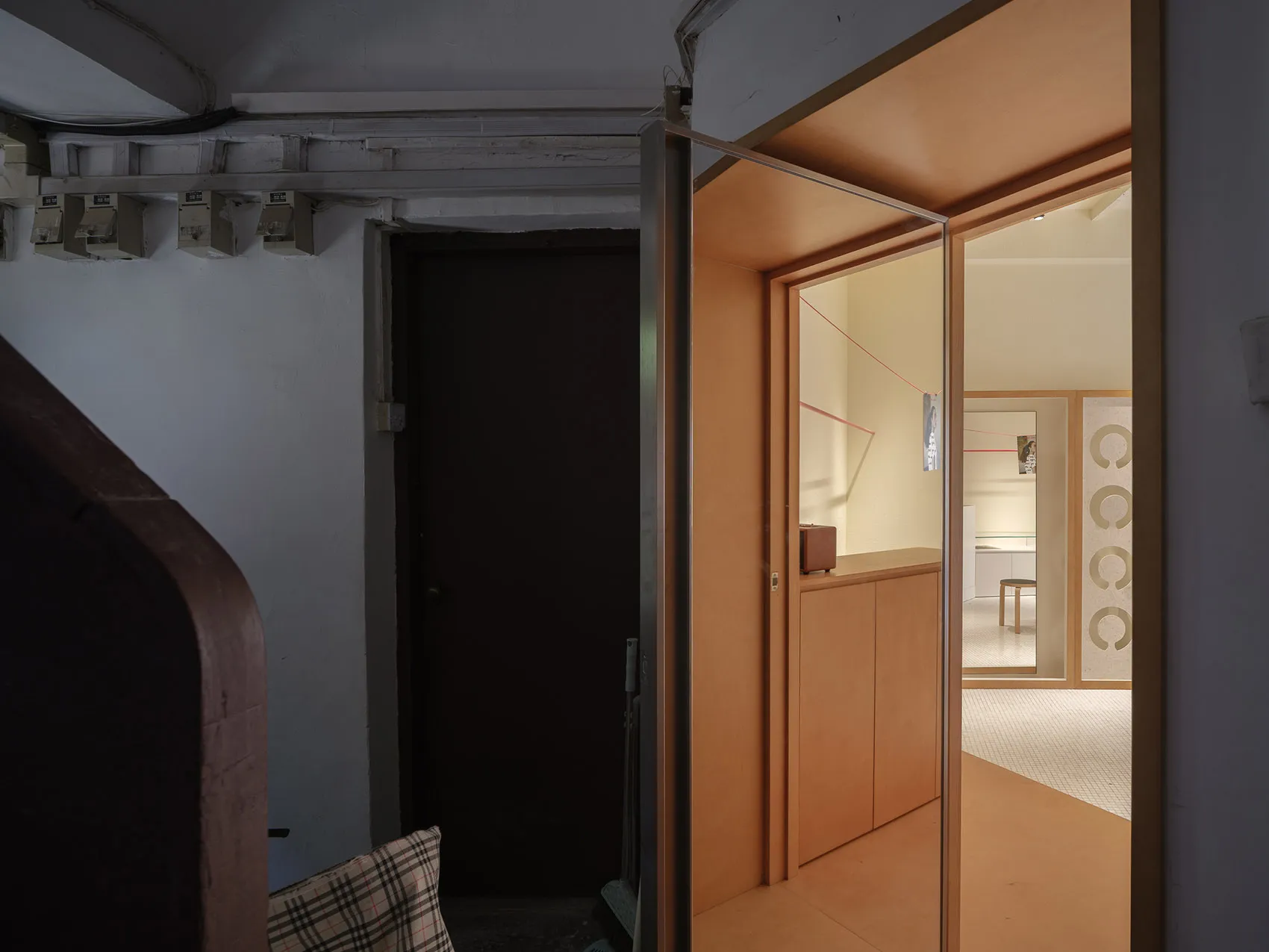 A modern interior of a home showcasing wooden furniture and minimalist design elements.